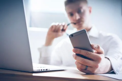 Close up image of serious businessman using smartphone Stock Photos