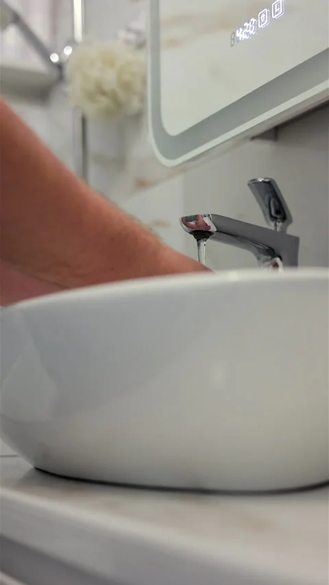 A Close-Up Image Showing A Hand Washing Under A Modern Faucet. Vertical. Video stock 294321099