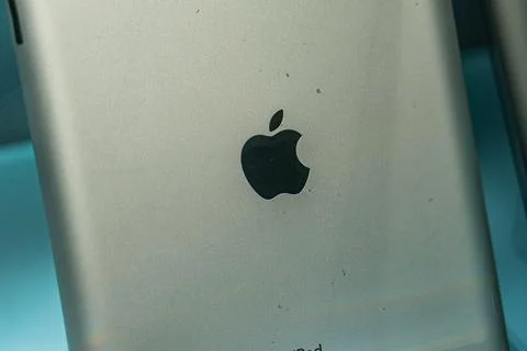 Close-up image of a silver Apple smartphone, featuring the iconic Apple logo  Stock Photos