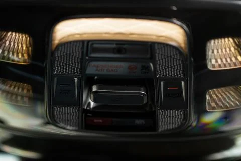 Close up image of the SOS button and car ceiling lamp in a car. Stock Photos