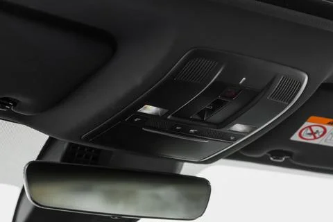 Close up image of the SOS button and car ceiling lamp in a car. Stock Photos