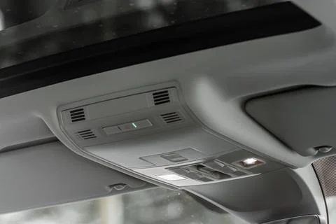 Close up image of the SOS button and car ceiling lamp in a car. Stock Photos
