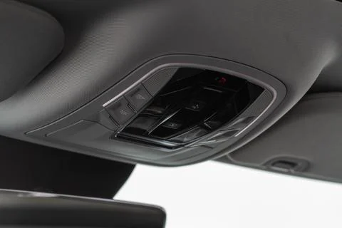 Close up image of the SOS button and car ceiling lamp in a car. Stock Photos