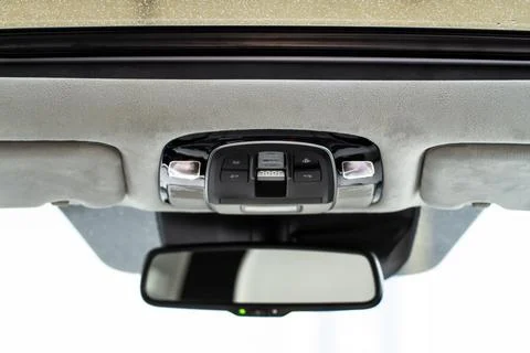 Close up image of the SOS button and car ceiling lamp in a car. Stock Photos