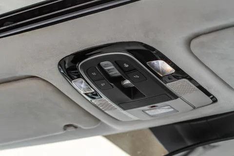 Close up image of the SOS button and car ceiling lamp in a car. Stock Photos