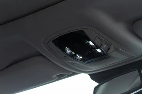 Close up image of the SOS button and car ceiling lamp in a car. Stock Photos