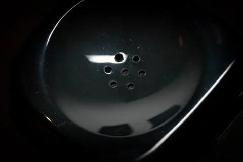 Close up image of speaker on an old analog phone. Stock Photos