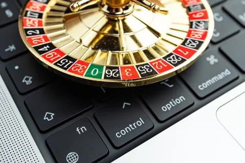 Close-up image of a spinning roulette wheel on a computer keyboard, symboli.. Stock Photos