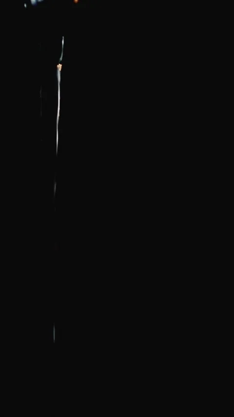 Close-up image of a stream of water flowing vertically against an undefined Stock Footage 333385402