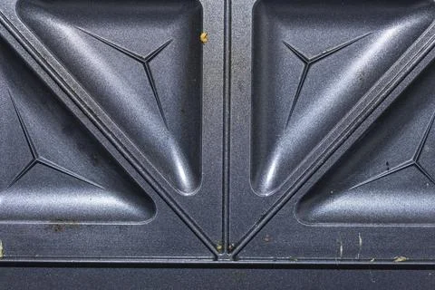 Close-up image of a textured dark surface featuring angular geometric shapes and Stock Photos