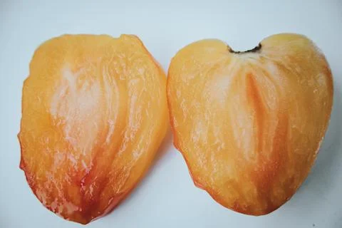 A close-up image of a thin slice of an orange tomato. Stock Photos