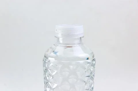 Close-up image of the top of a plastic bottle filled with water and its lid.. Stock Photos