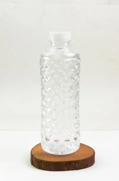 Close-up image of the top of a plastic bottle filled with water and its lid.. Stock Photos