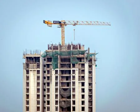 Close up image of tower Crane over building in Sunlight , under constructio.. Stock-Fotos