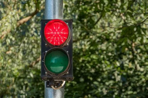 Close-up image of two traffic lights at an intersection, one red and one gree Stock Photos