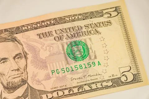 Close-up image of two US 5 bills, highlighting Abraham Lincolns portrait, s.. Stock Photos