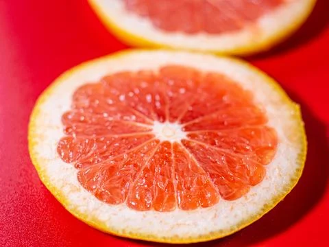 Close-up image of a vibrant grapefruit slice showing detailed pulp and segments. Фото