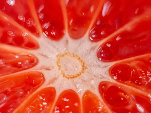 Close-up image of a vibrant grapefruit slice showing detailed pulp and segments. Stock Photos