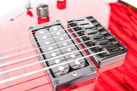 Close-up image of a vibrant red electric guitar headstock, prominently feat.. 스톡 사진
