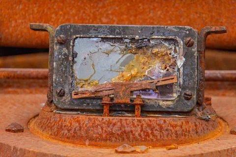 A close-up image of a weathered, rusted metal object with rounded corners T.. Stock Photos