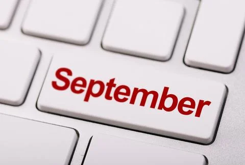 Close-up image of a white keyboard with a red "September" key, symbolizing .. Stock Photos