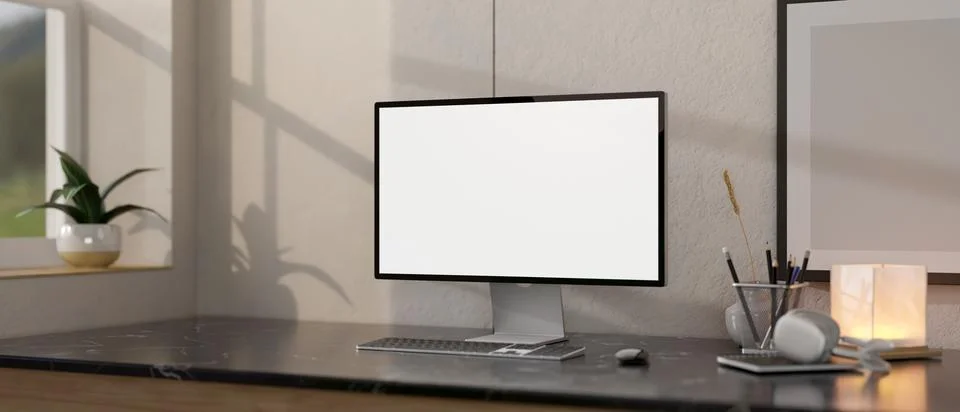 Close-up image of a white-screen computer mockup on a black marble table in.. Illustrazione stock