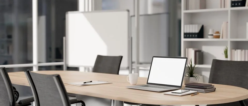 Close-up image of a white-screen laptop computer on a wooden meeting table .. イラスト素材