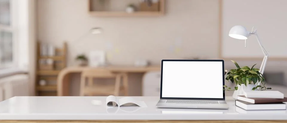 Close-up image of a white-screen laptop computer on a white tabletop in a m.. Stockillustratie