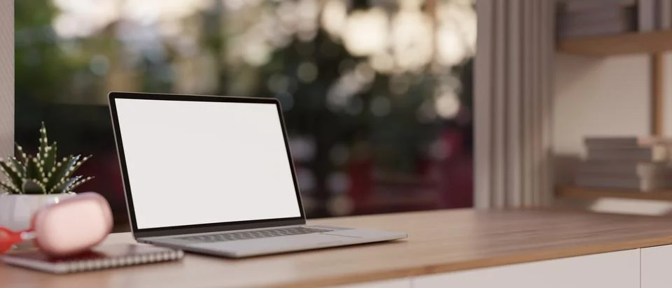 Close-up image of a white-screen laptop computer and accessories on a woode.. Stockillustratie