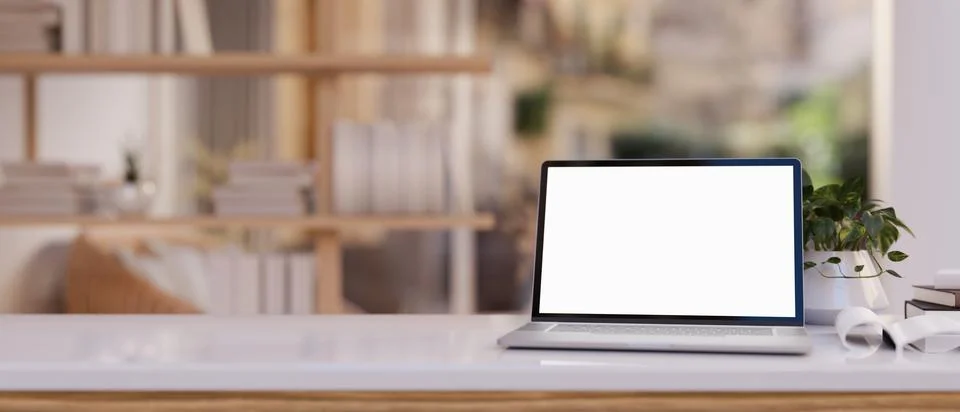Close-up image of a white-screen laptop computer and accessories on a woode.. Stock Illustration