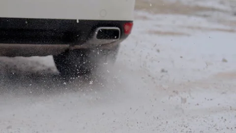 Close-up image of the winter tires of the car drifting through the snow and Stock Footage 305676485