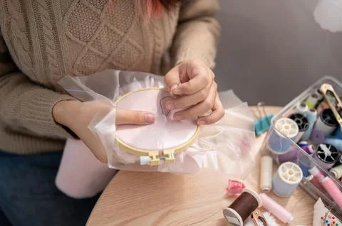 A close-up image of a woman threading a pattern on an embroidery frame, han.. 写真素材