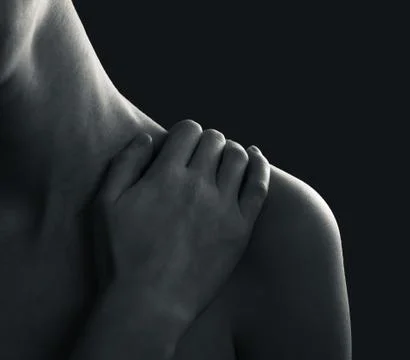 A close-up image of woman's hand lying on her shoulder Stock Photos