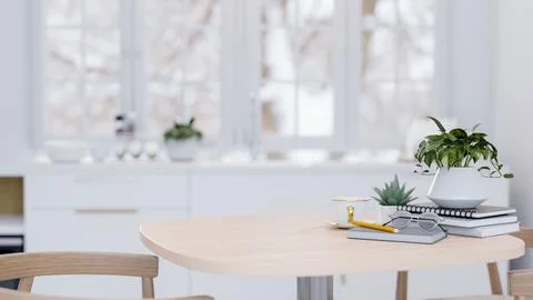 A close-up image of a wooden table in a minimalist white kitchen at home. Ilustración de archivo