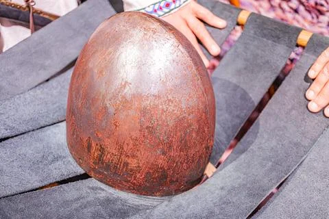 A close-up image in a workshop setting, featuring a copper-like dome-shaped o Stock Photos