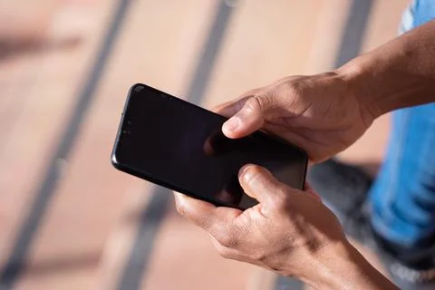 Close-up image of a young man's hands using a smartphone Stock Photos