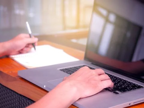 Close up image of young people using laptop technology and Writing Notebook W Stock Photos