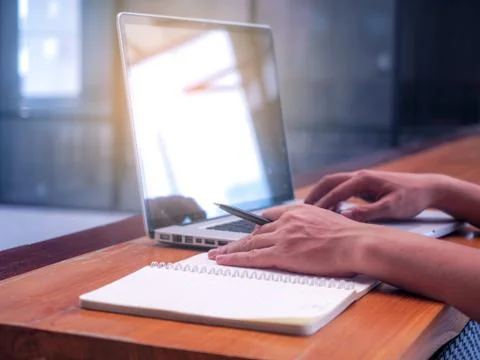 Close up image of young people using laptop technology and Writing Notebook W Stock Photos