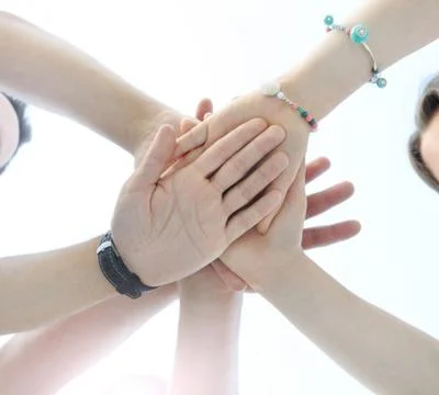 Close up image of young students making a stack of hands Stock Photos
