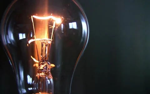 Close-up of Incandescent Light Bulb with Glowing Tungsten Filament 4K 動画素材 339268370