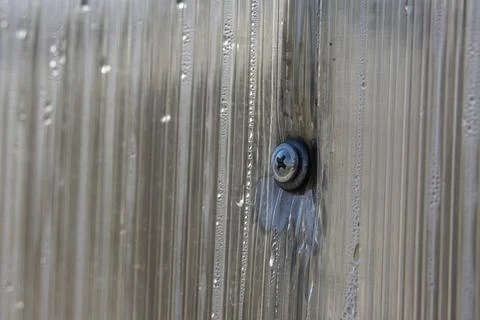 Close-up of incorrect fastening of a polycarbonate sheet. Damaged polycarbona Stock Photos