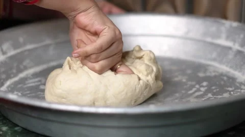 Close Up of Indian Baker Hand Kneading Soft Wheat Flour Dough in Metal Plate. Stock Footage 339871140