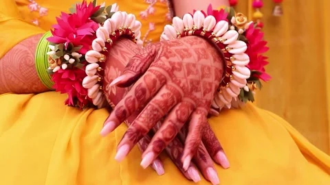 Close-Up of Indian Bride Hands with Mehndi During Traditional Haldi Ceremony Stock Footage 329384416