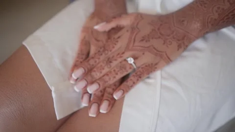 Close-up of Indian bride's hands covered with mehndi. Indian wedding ceremony. Stock Footage 252759912
