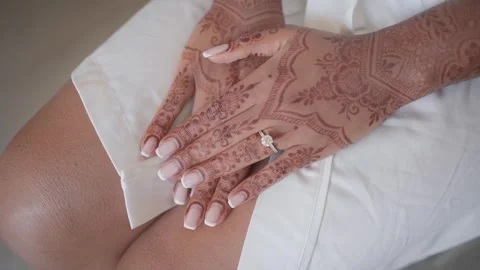 Close-up of Indian bride's hands covered with mehndi. Indian wedding ceremony. Stock Footage 254327443