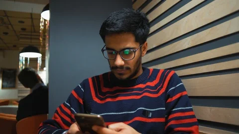 Close-up, Indian Guy Communicates with Smartphone in Cafe Stock Footage 101651245