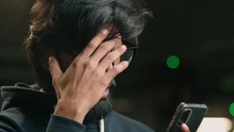Close up Indian man at dark parking lot shocked stressed annoyed disappointed Stock Footage 250453239