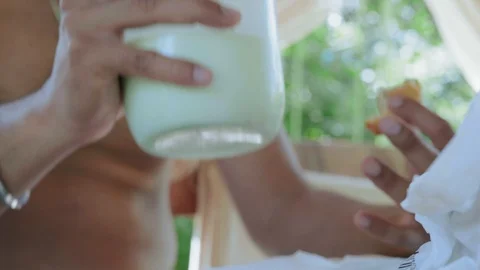 Close-up, Indian Man Drinks Milk from Banks Sitting at the Table Stock Footage 113155060