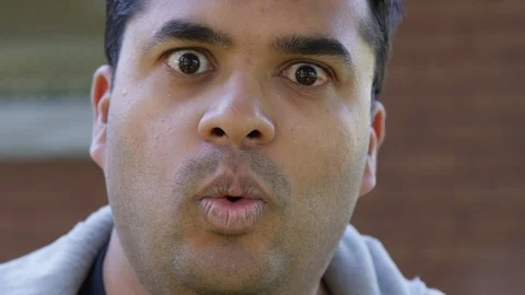 Close Up - Indian man exclaims to the camera his disbelief - Slow Motion - shot Stock Footage 125089561