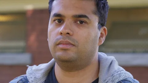 Close Up - Indian man looks into the camera with a straight face, very serious - Stock Footage 125088253